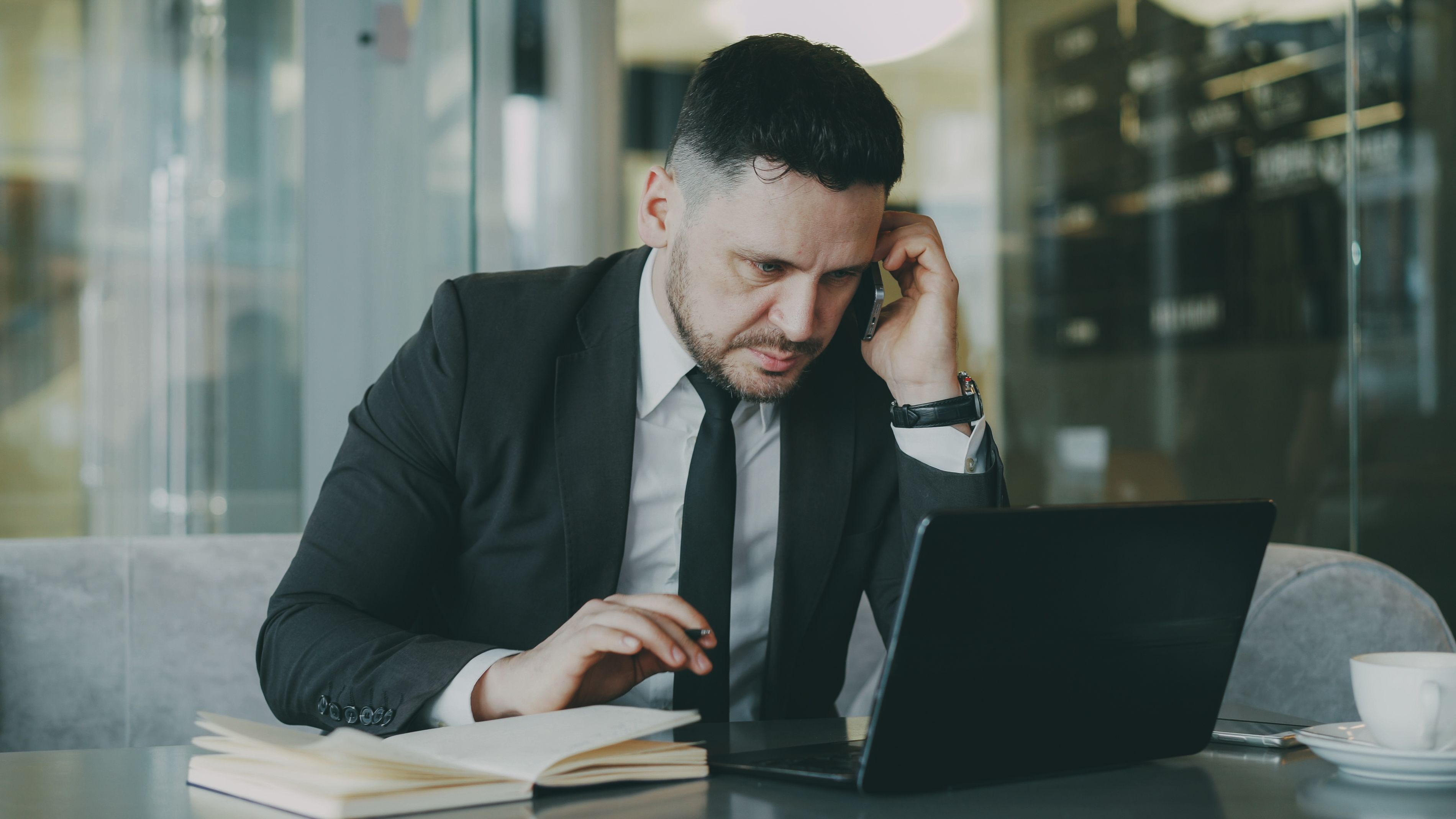 Person reviewing a lead on their phone while working